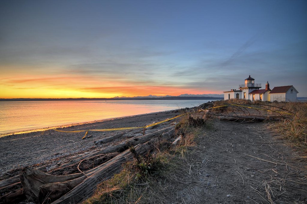 Sunset behind lighthouse at Discovery Park in Seattle