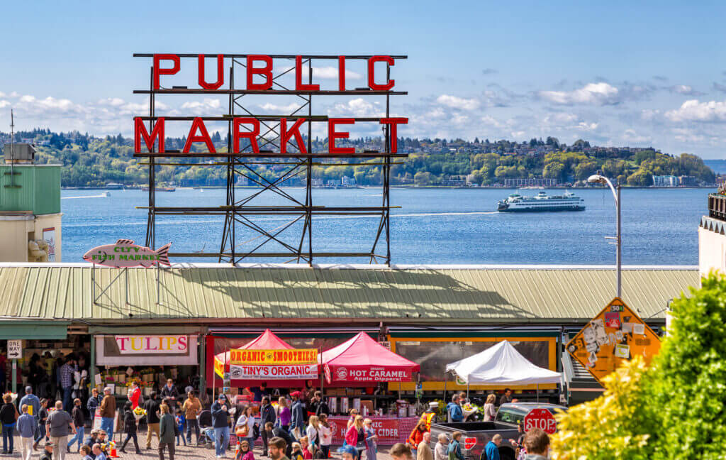 Visitors exploring Pike Place Market in Seattle on a sunny August day